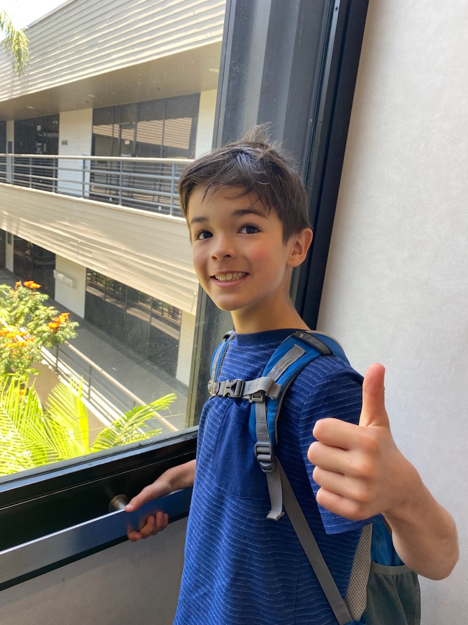 Smiling boy giving a thumbs up